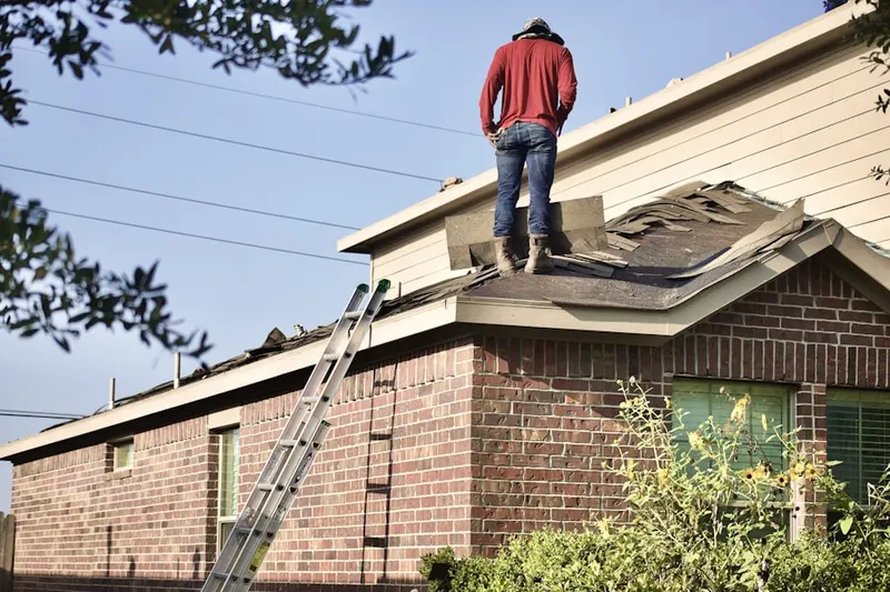 Professional roofer working on a residential roof in Watts Hospital-Hillandale